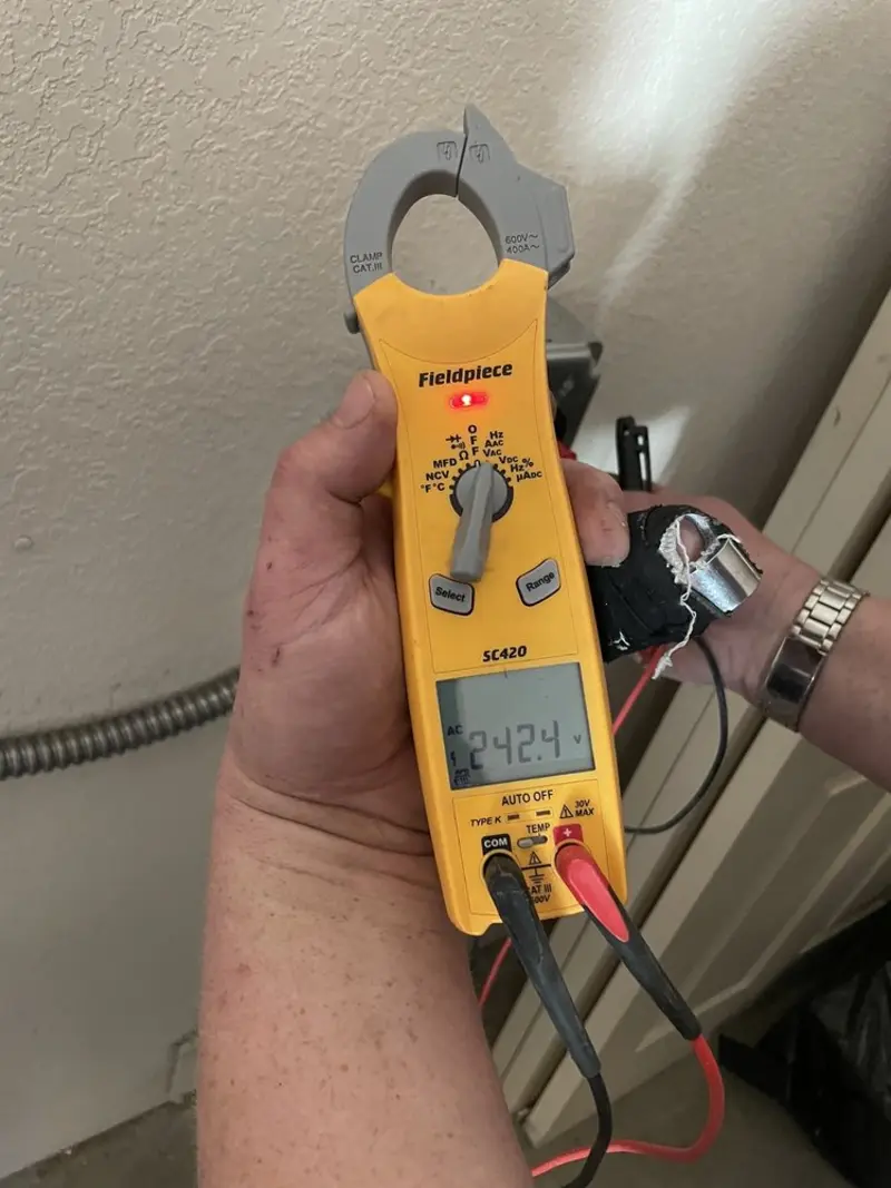 Voltage testing with clamp meter during Ceiling Fan Installation in Grimes